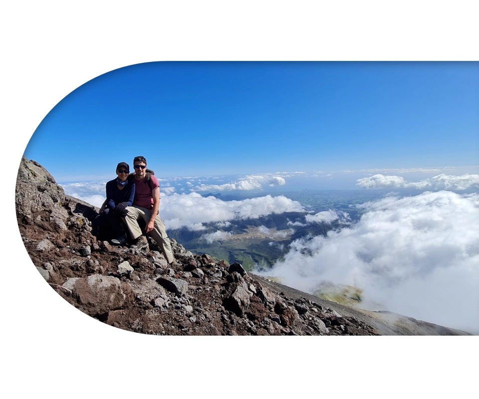 The owners of Atelier Palomar sitting on a mountain.